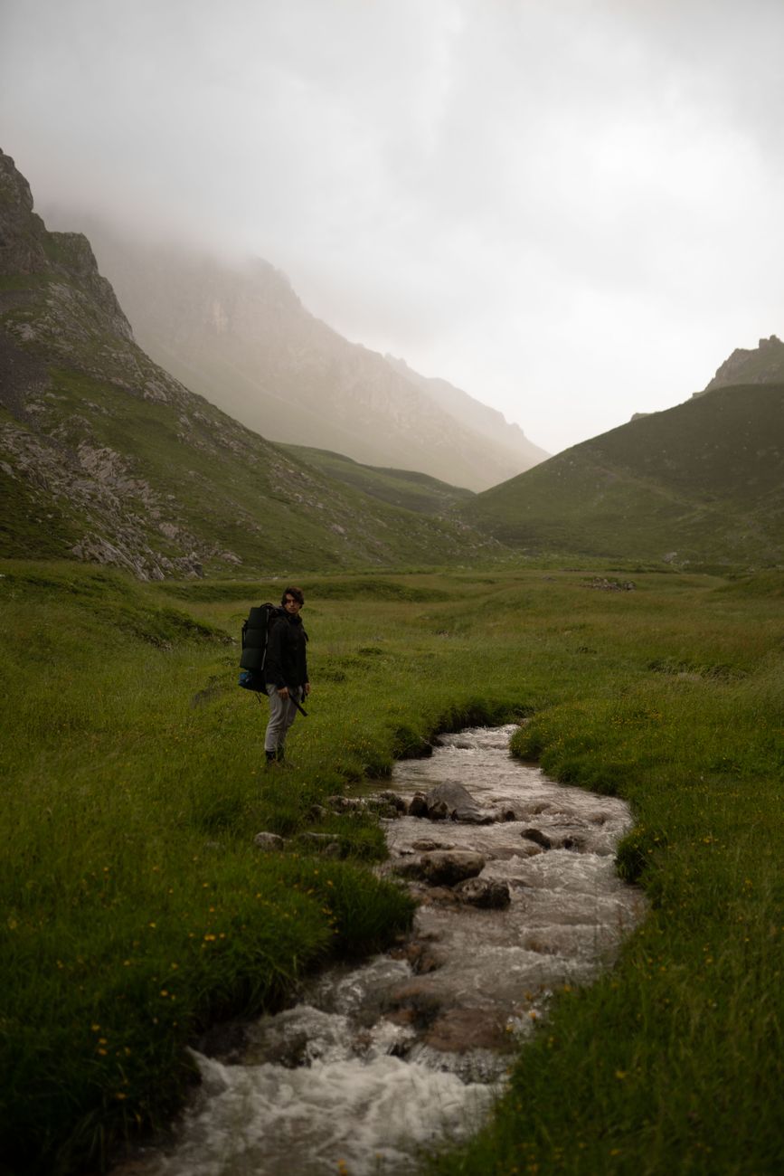 Hiker in misty mountain valley